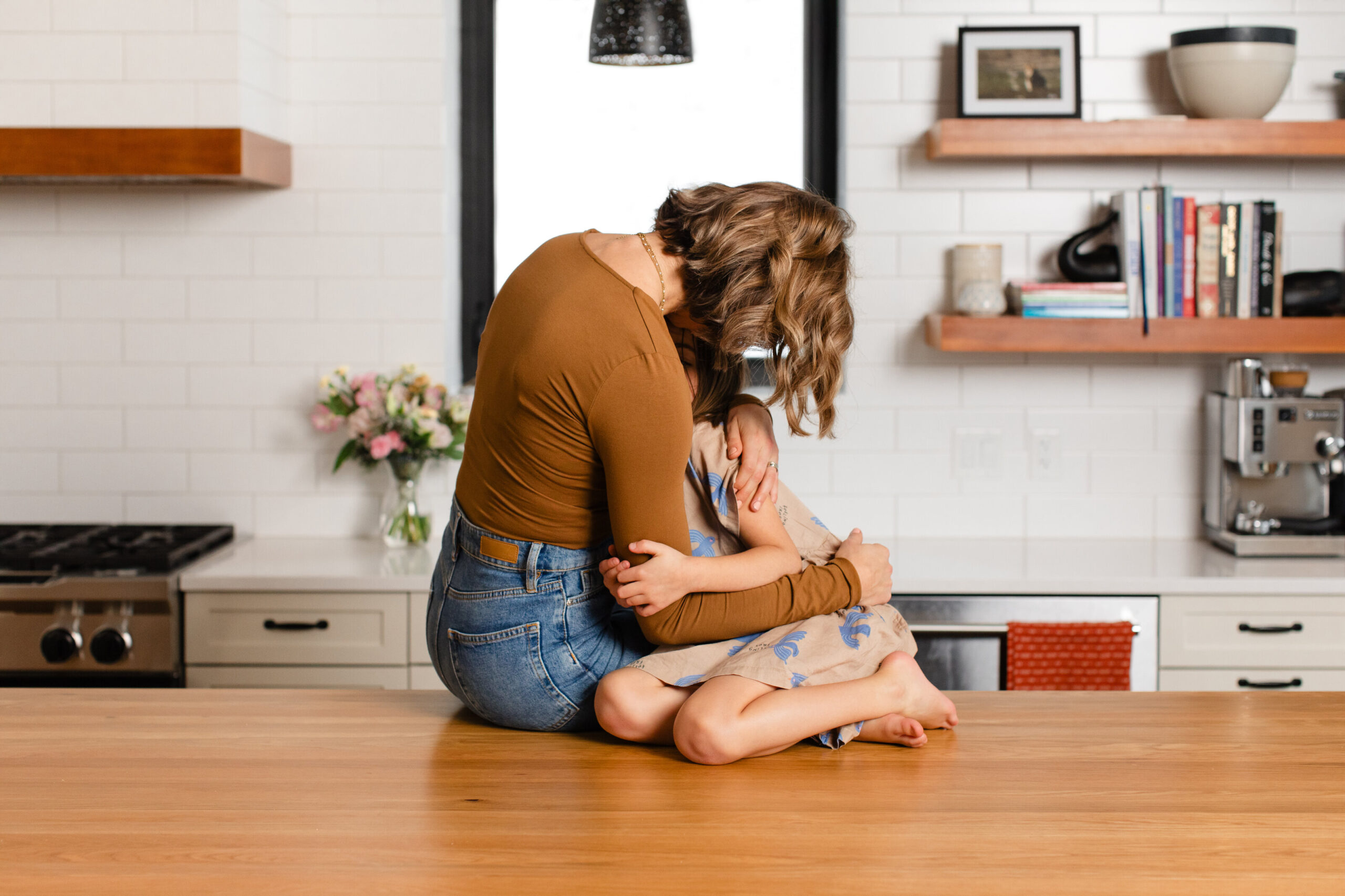 mother hugging her upset daughter